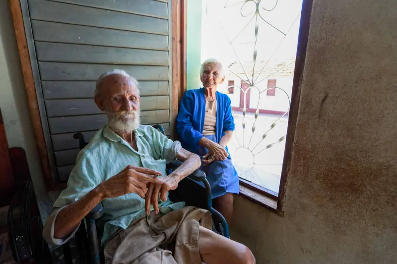 A husband and wife, members both, watching the street from the front window
