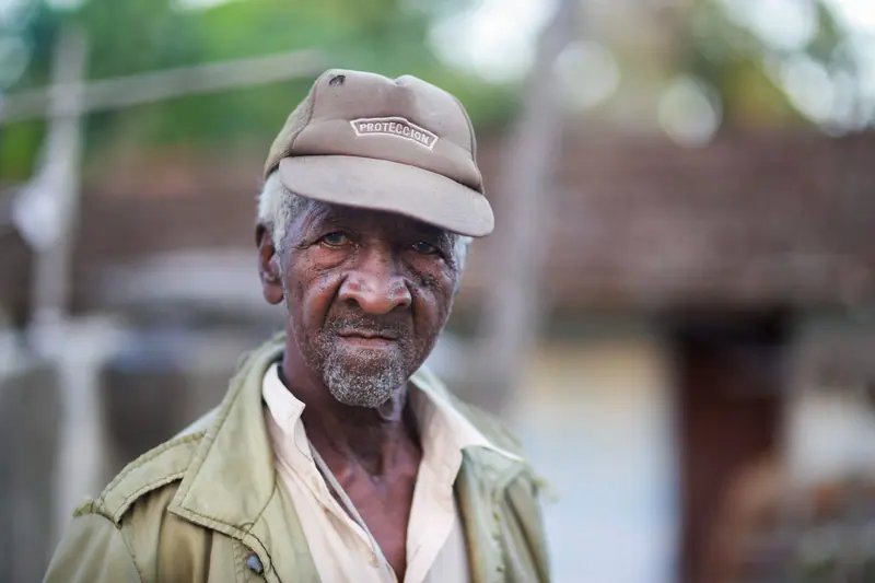 A member in his feed cap on the porch