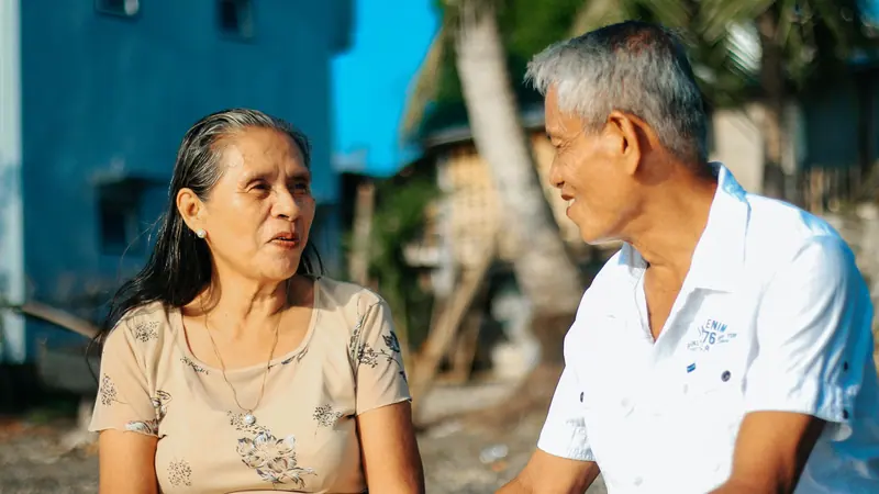 A member and her husband talking on the patio