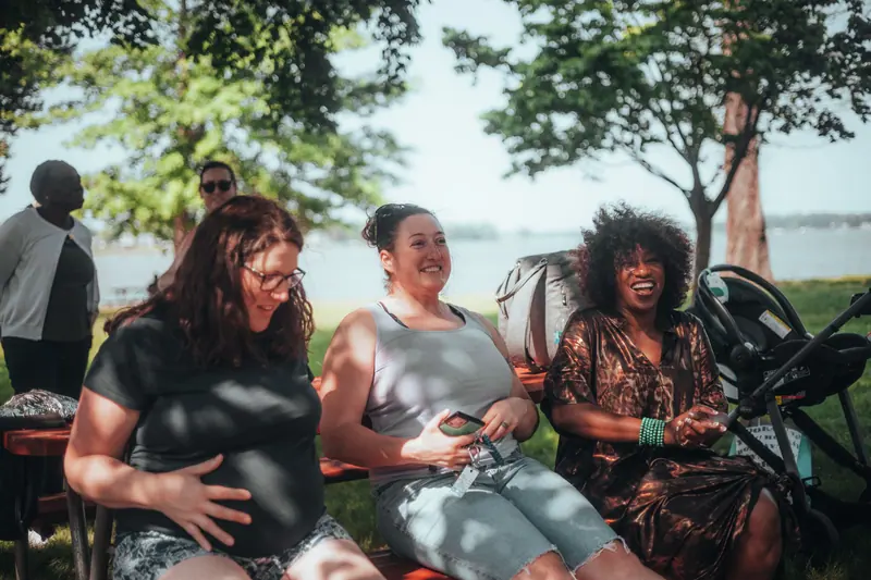 Members laughing together on the patio