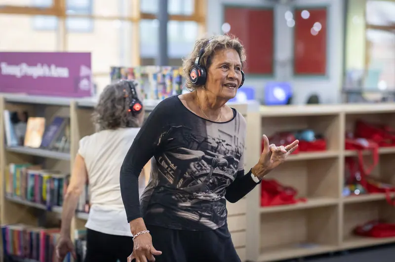 Two members dancing with headphones on during music and memory