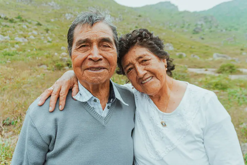 A married couple arm in arm on the walking path