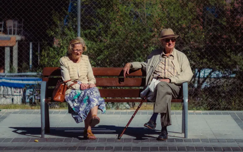 A couple resting on a bench downtown