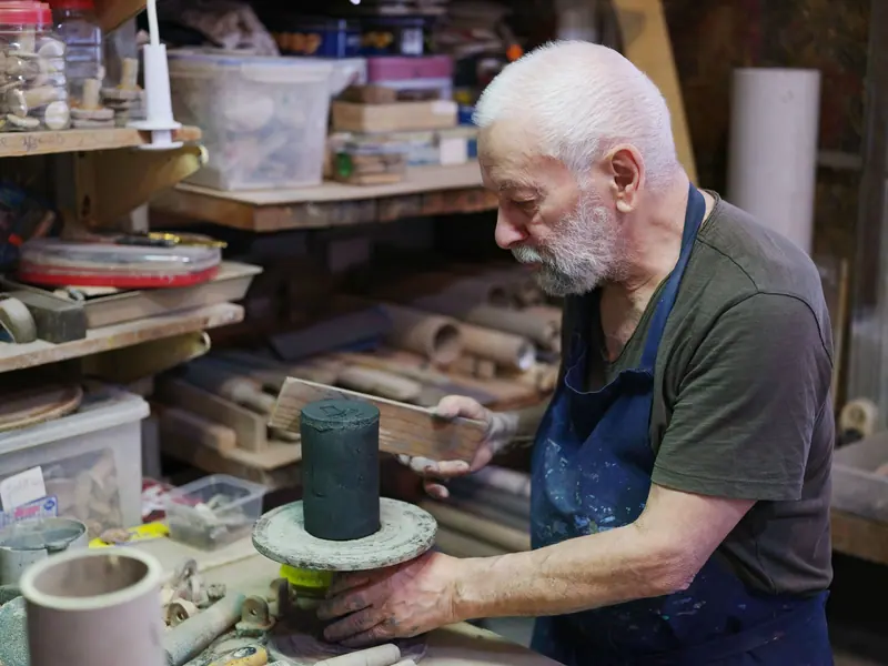 A member at the potter's bench in the woodshop