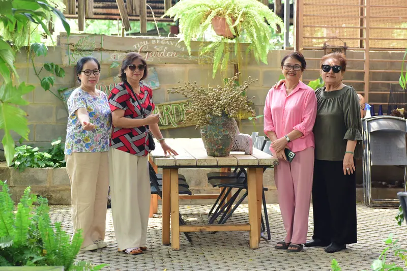 Members and staff gathered on the garden patio