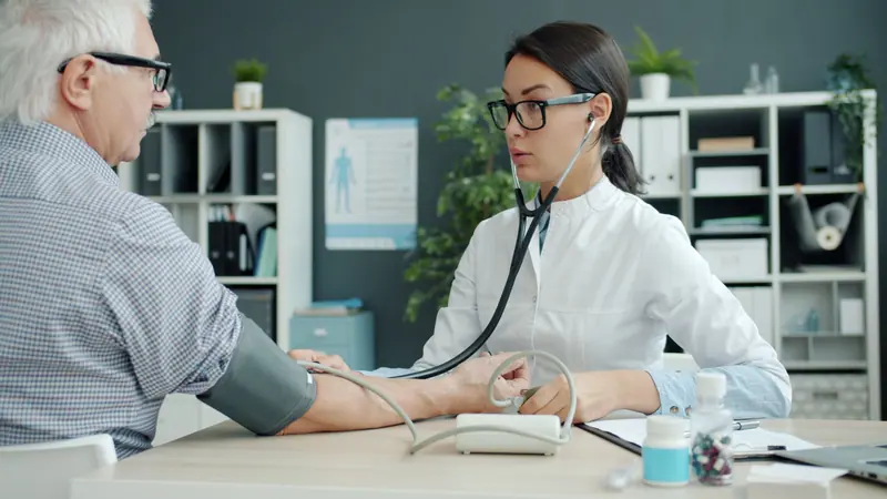 A nurse checking a member's blood pressure
