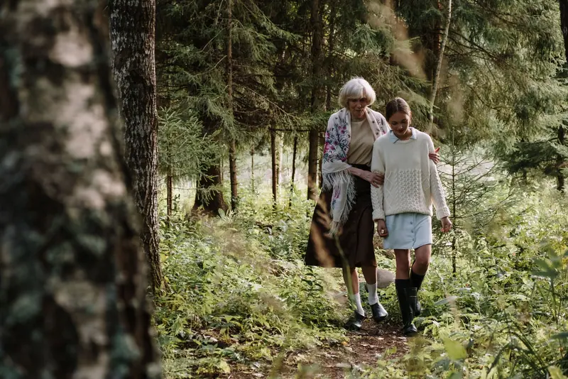 A couple walking the wooded trail