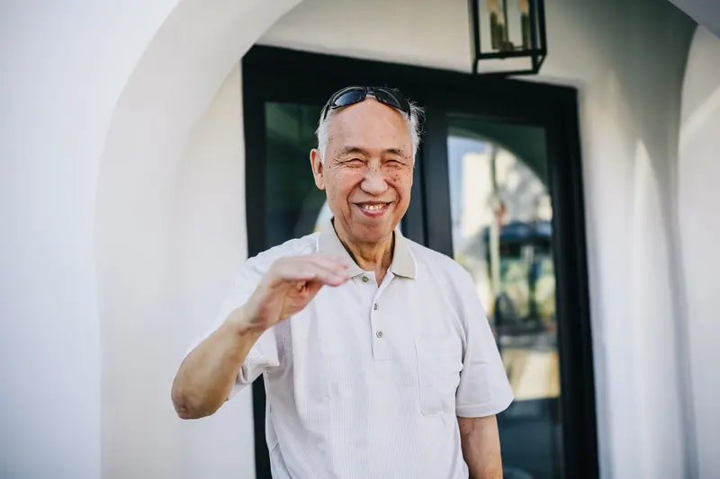 A resident smiling in the courtyard