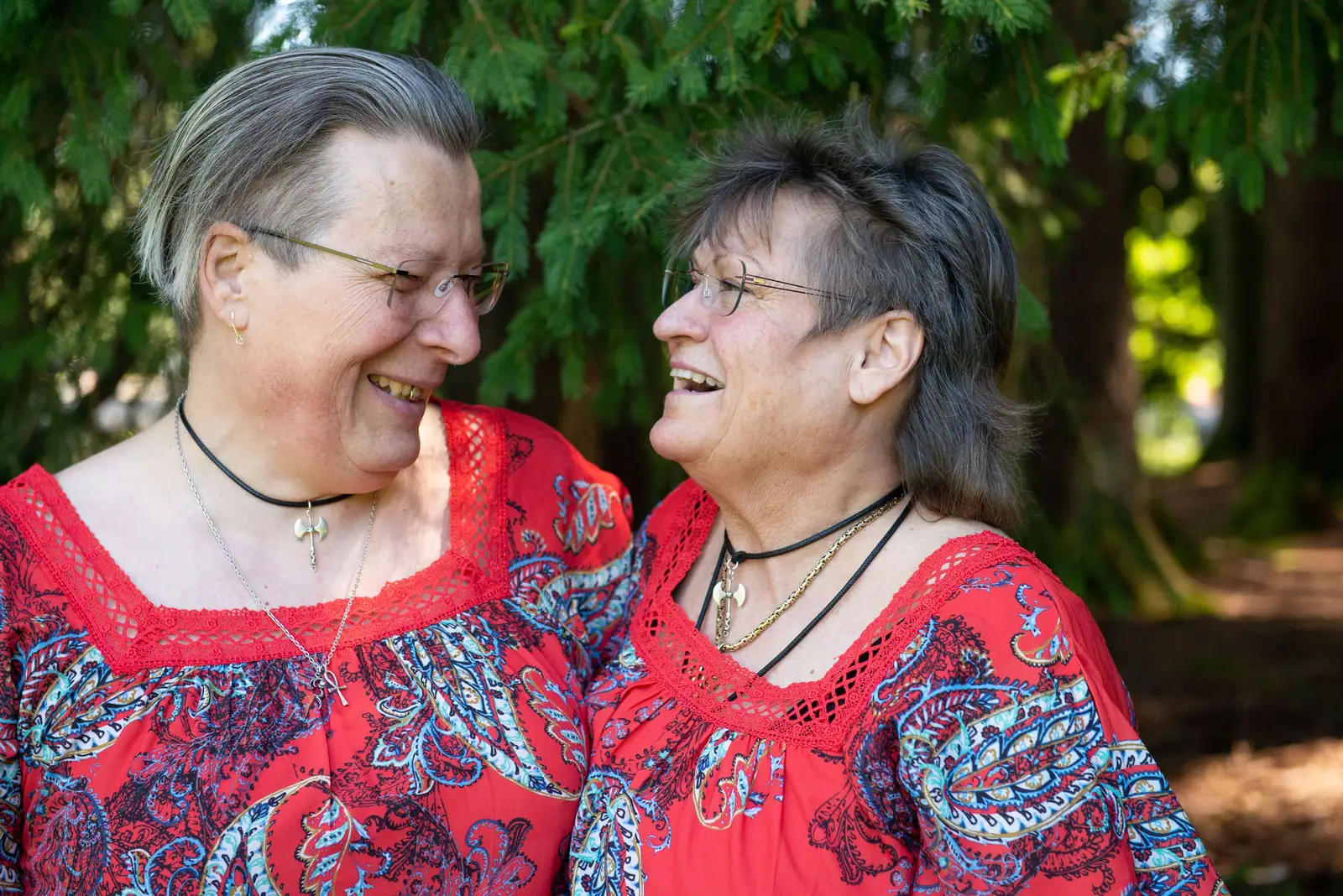 Two longtime members laughing together outside after noon dinner