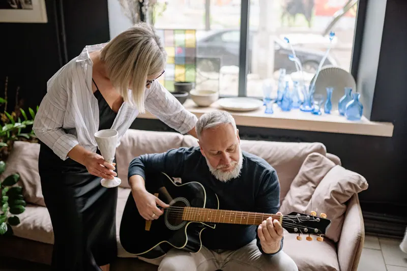 A guitar lesson in the sitting room