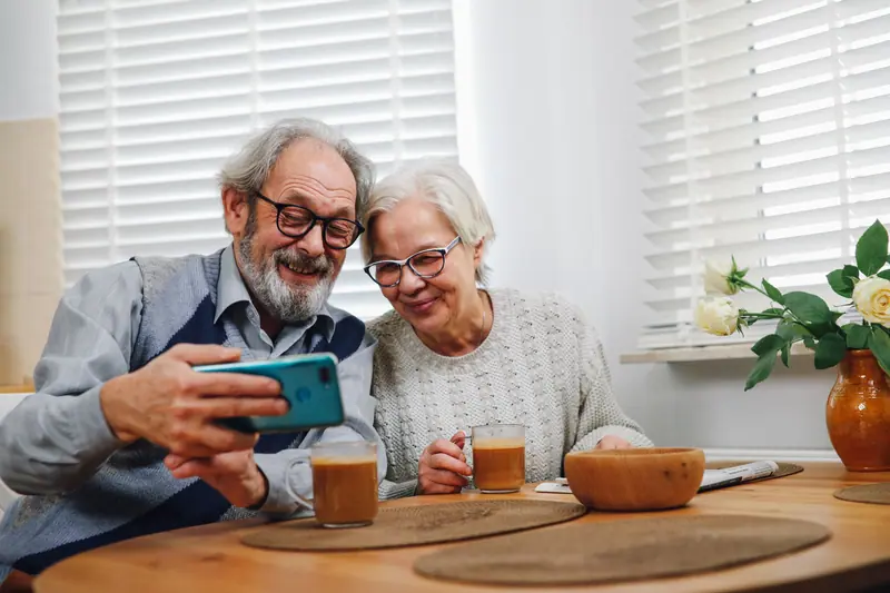 A couple taking a selfie over morning coffee