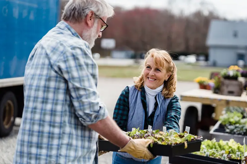 A couple trading seedling trays
