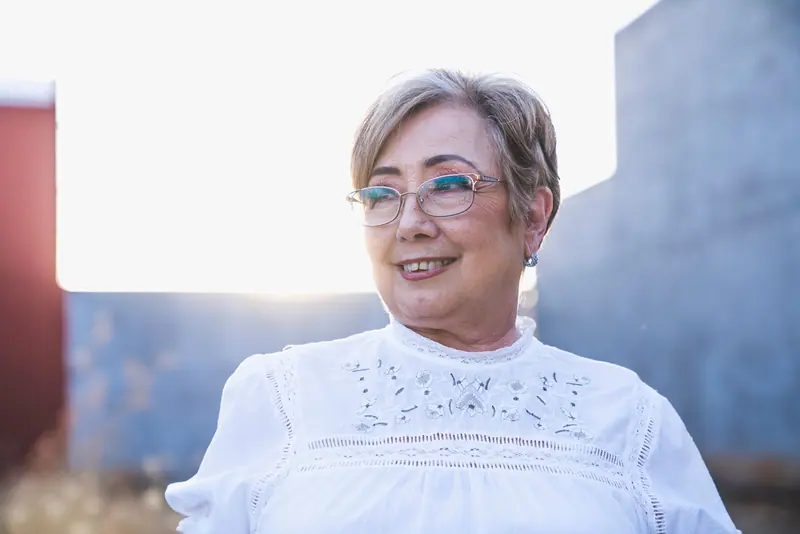 A resident smiling in the courtyard light