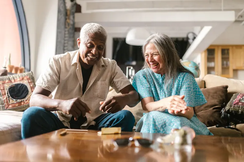 A member and a volunteer laughing over a game