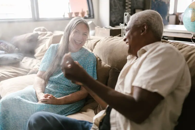 Two members trading stories on the lounge couch