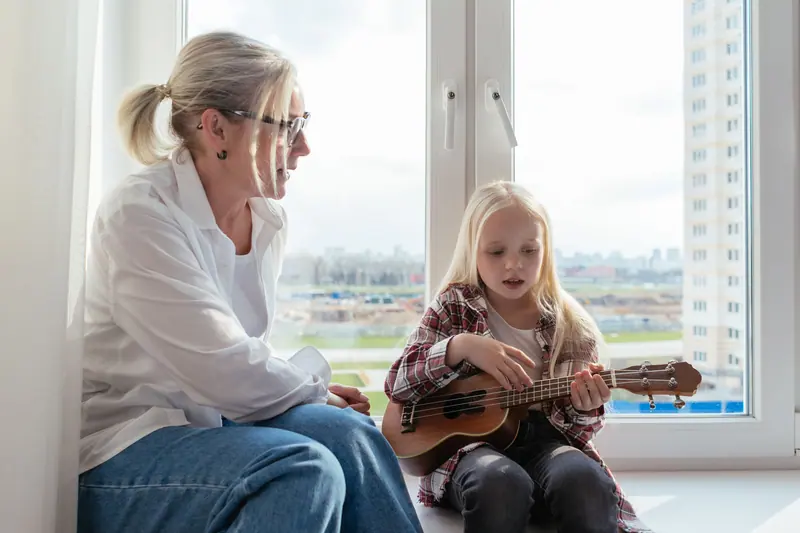 A resident reading with her granddaughter