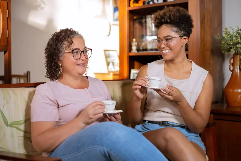 A resident and her daughter over coffee