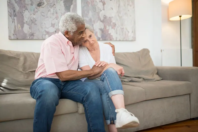 A couple resting on the quiet-room sofa