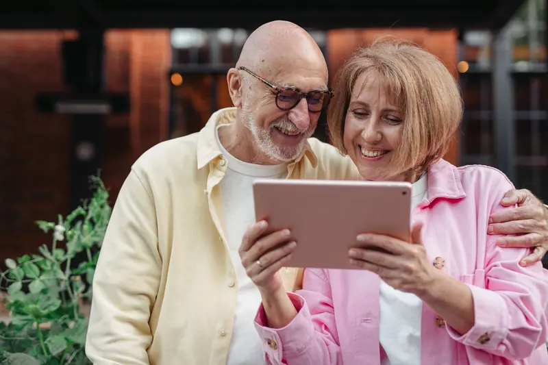 A couple looking at photos on a tablet