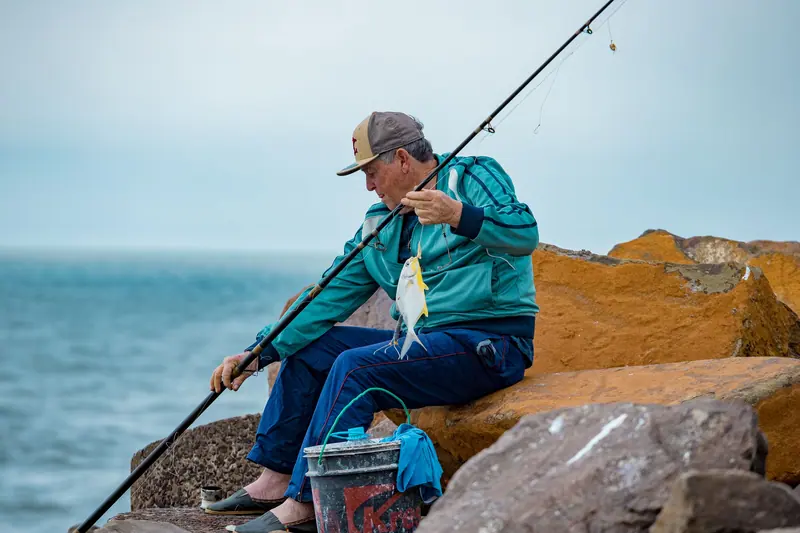A member fishing on a lake outing