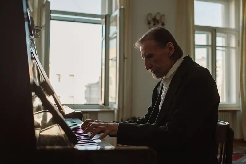 A resident playing the piano in the sunny parlor