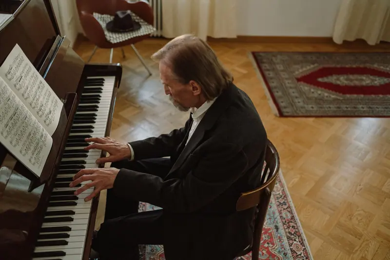 A resident at the piano in the parlor with sheet music open