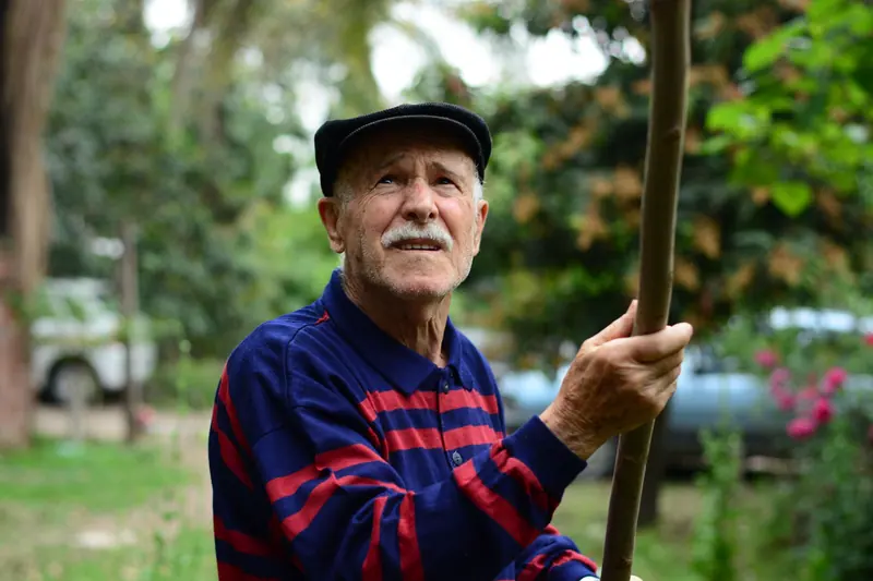 A resident with his walking stick in the park