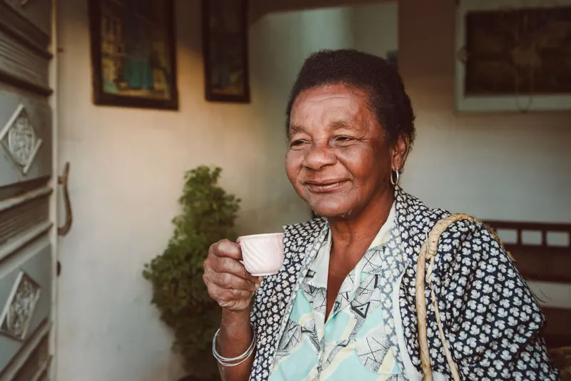 A resident with her morning coffee in the front hall