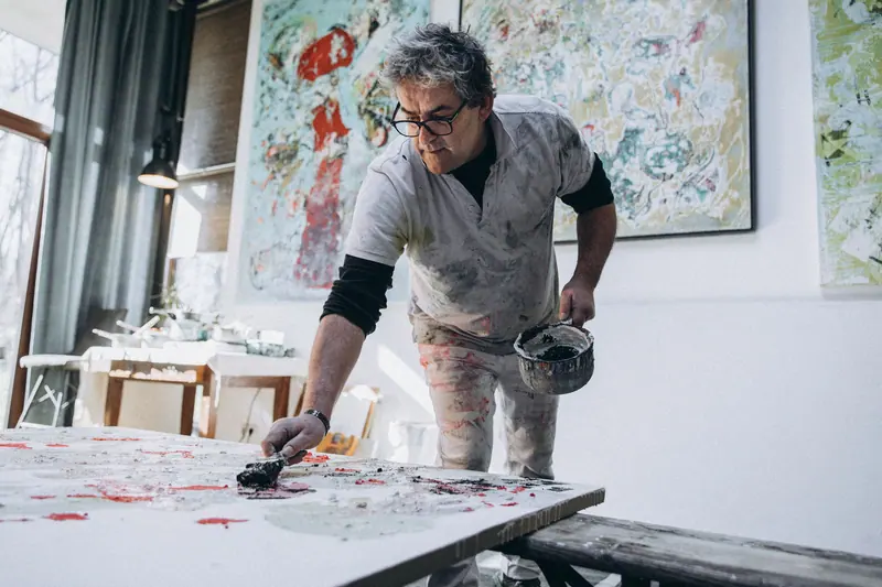 A resident working on a large canvas