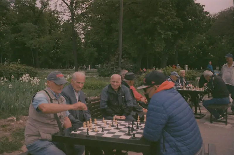 Residents bent over chess boards on the patio