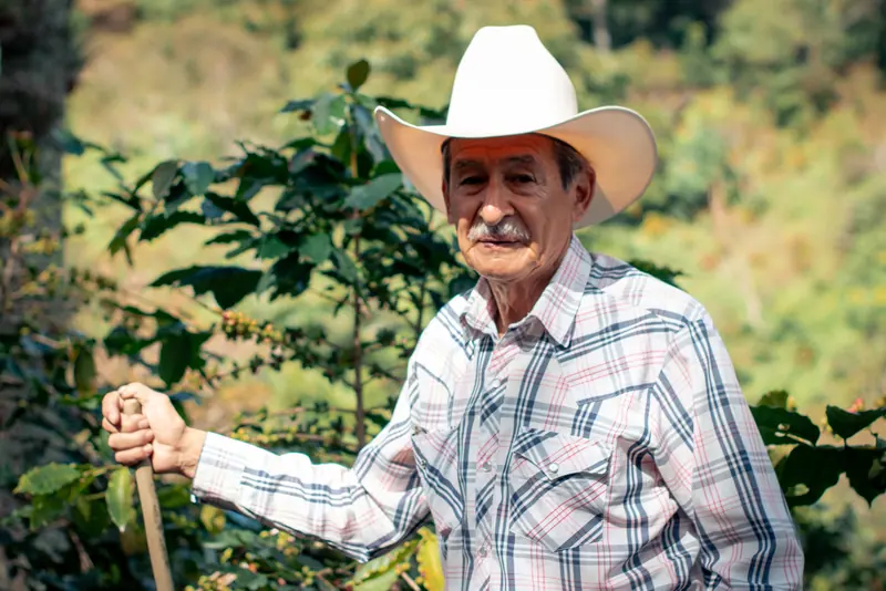 A resident in a cowboy hat out by the fence line