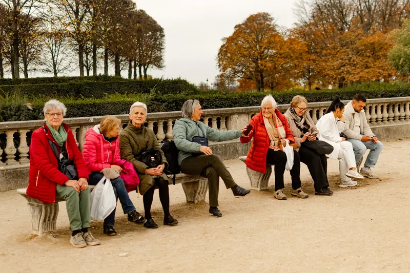 Friends resting on a bench on the fall outing