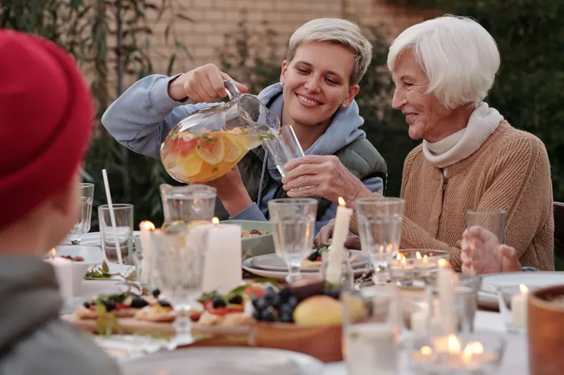 Family supper on the patio with a pitcher of lemonade