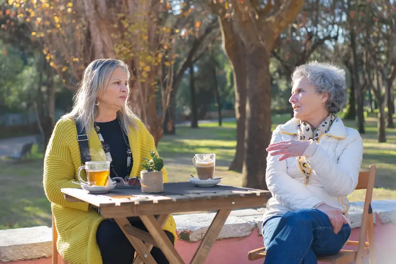 Two friends at tea under the oaks