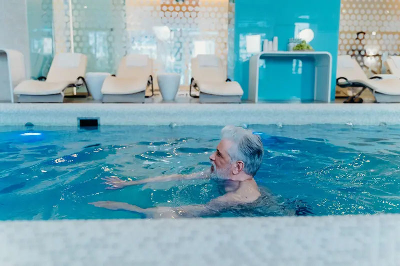 A resident taking his morning swim in the indoor pool