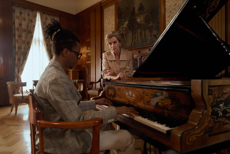 A resident teaching an afternoon piano lesson in the library