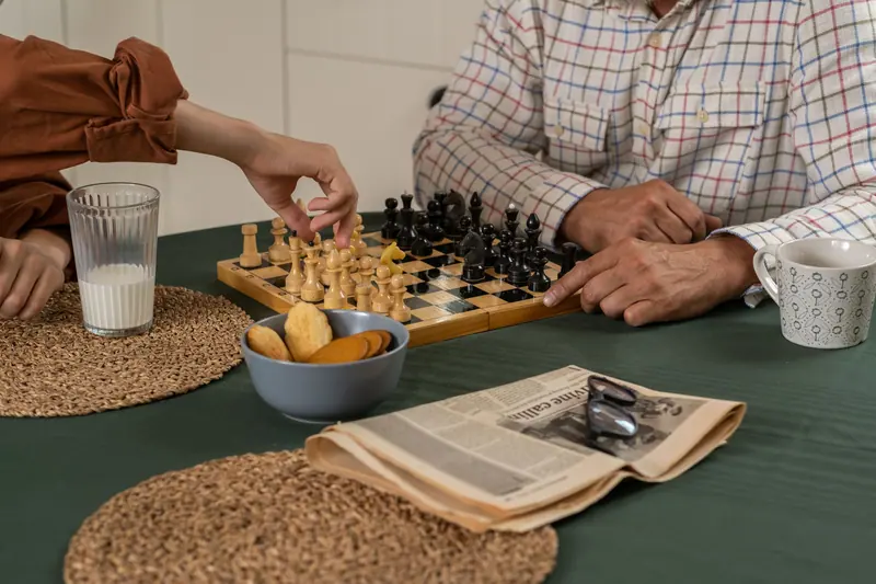A grandfather and grandson at chess