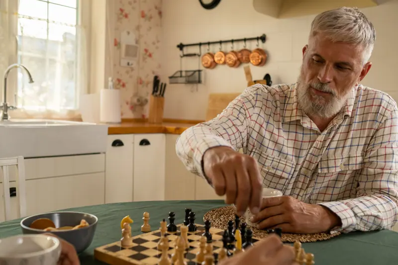 A resident setting up the chess board