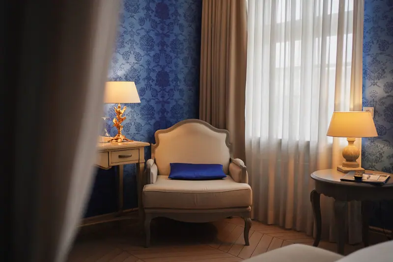 Elegant hotel room with classic furniture, soft lighting, and warm ambiance.
