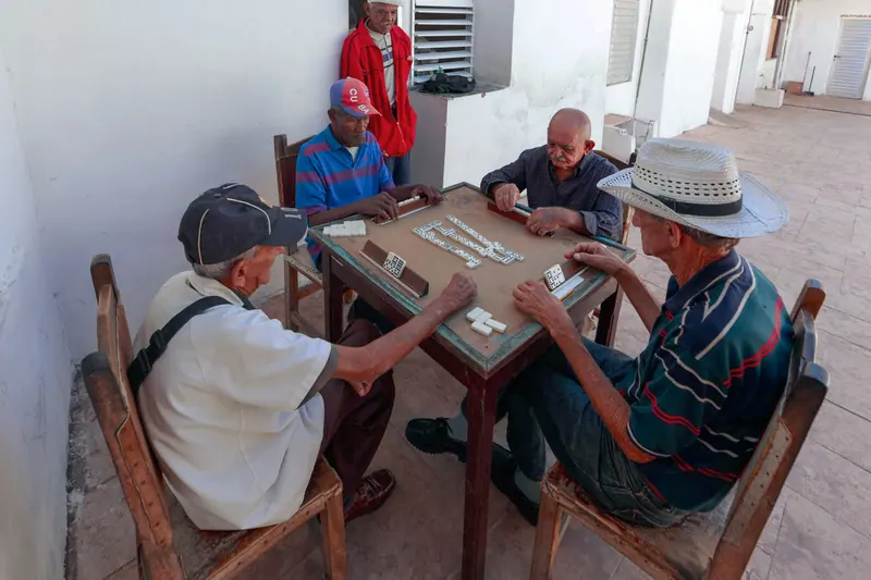 The dominoes regulars at the outdoor table