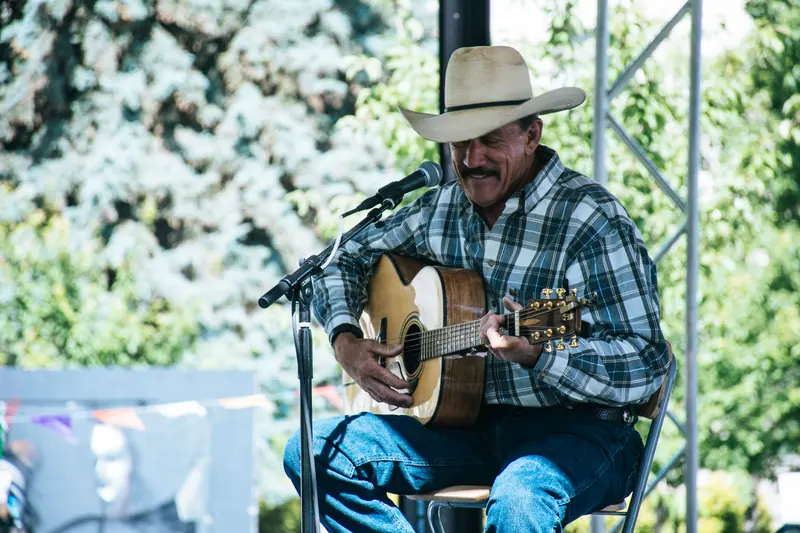 A resident in a cowboy hat playing at the Saturday music jam