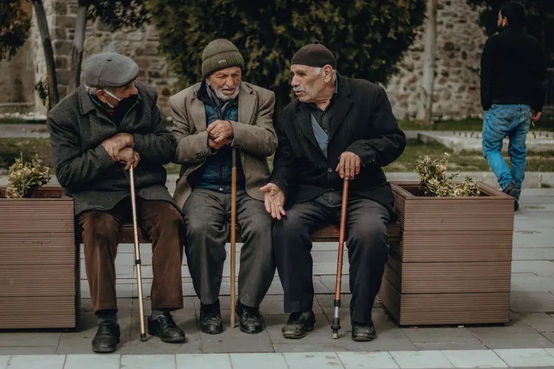 Three friends visiting on a cold day