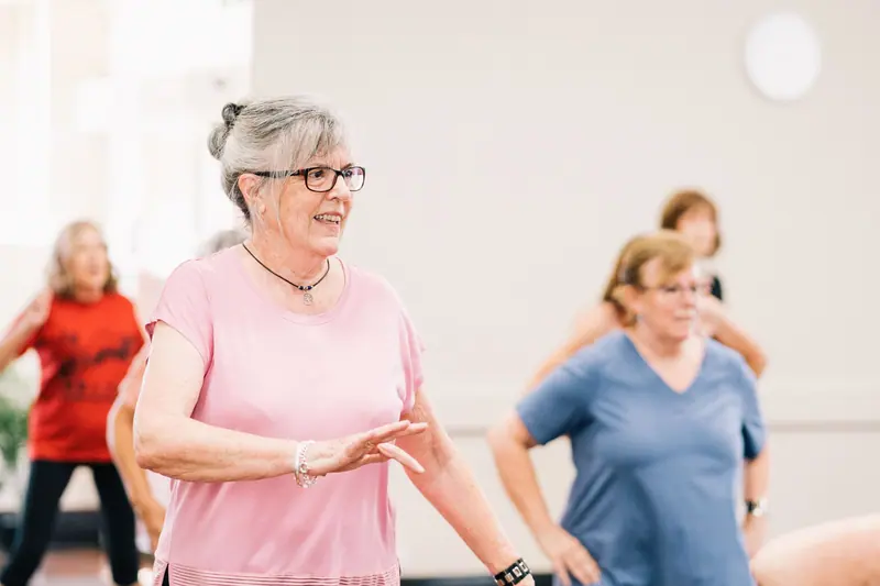 Residents in a lively dance fitness class