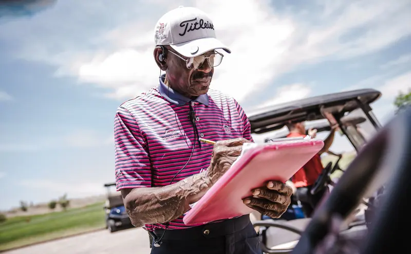 A resident marking his scorecard at the golf course