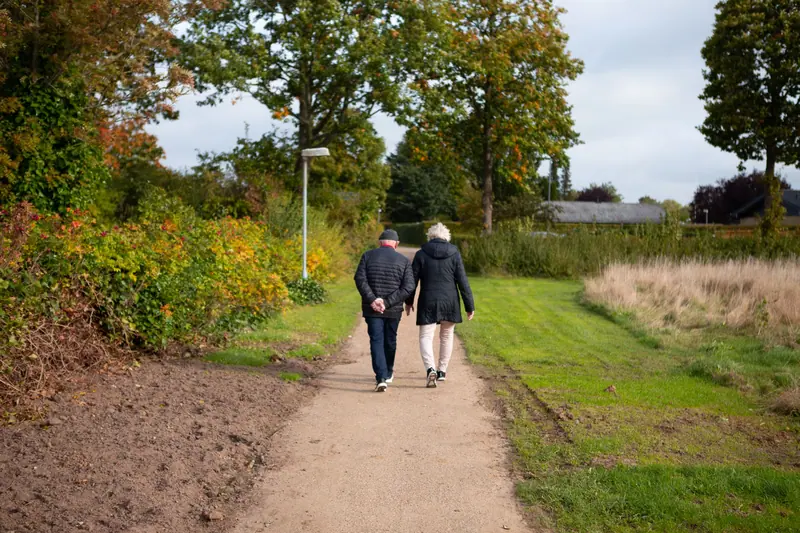 A couple on a gravel road in fall