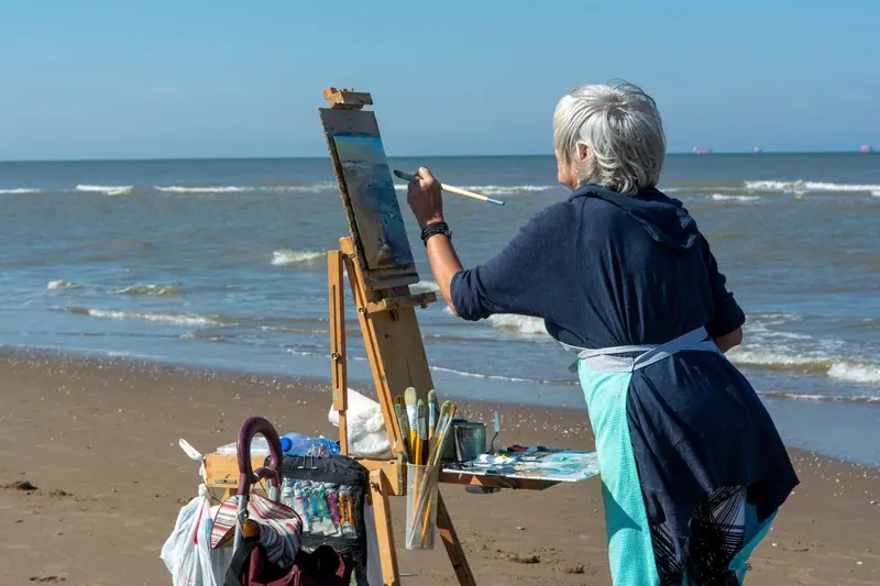 A resident painting on the beach