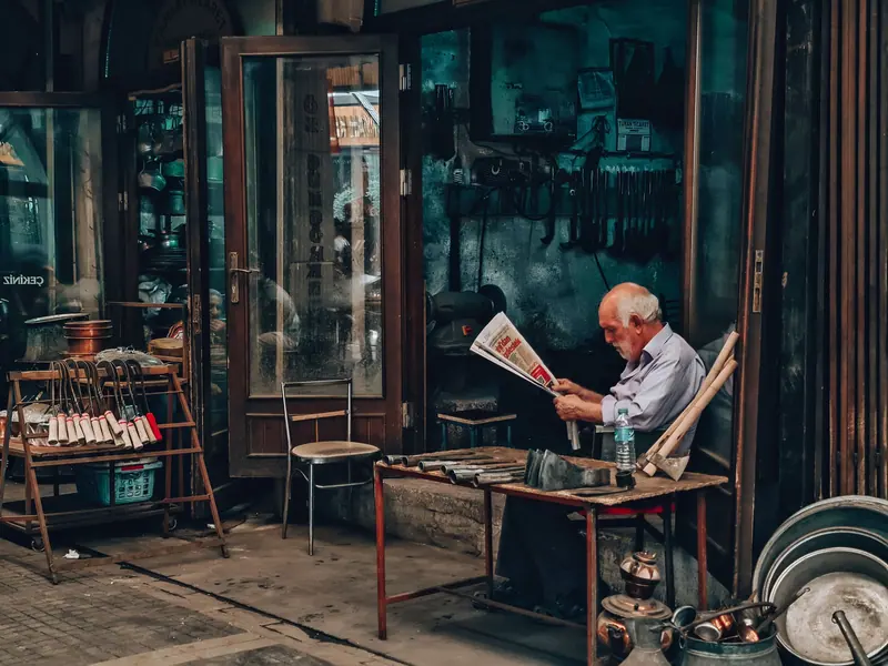 A resident reading outside the shop
