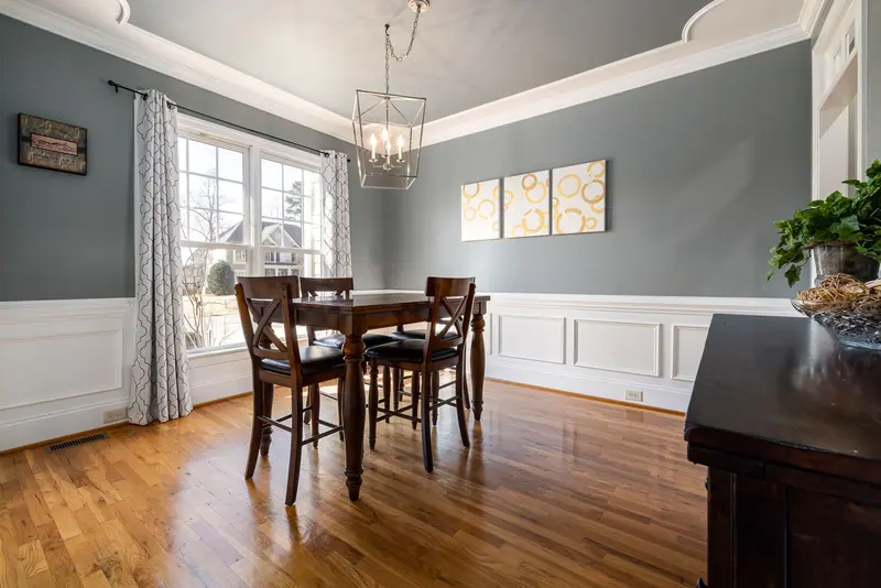A casita dining room with a chandelier and wainscoting