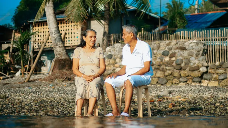 A couple sitting by the water