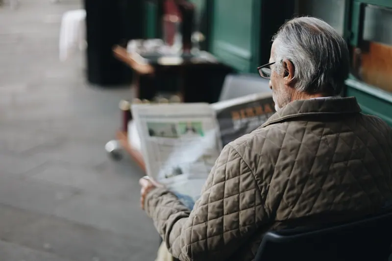 A resident reading the paper in the lobby